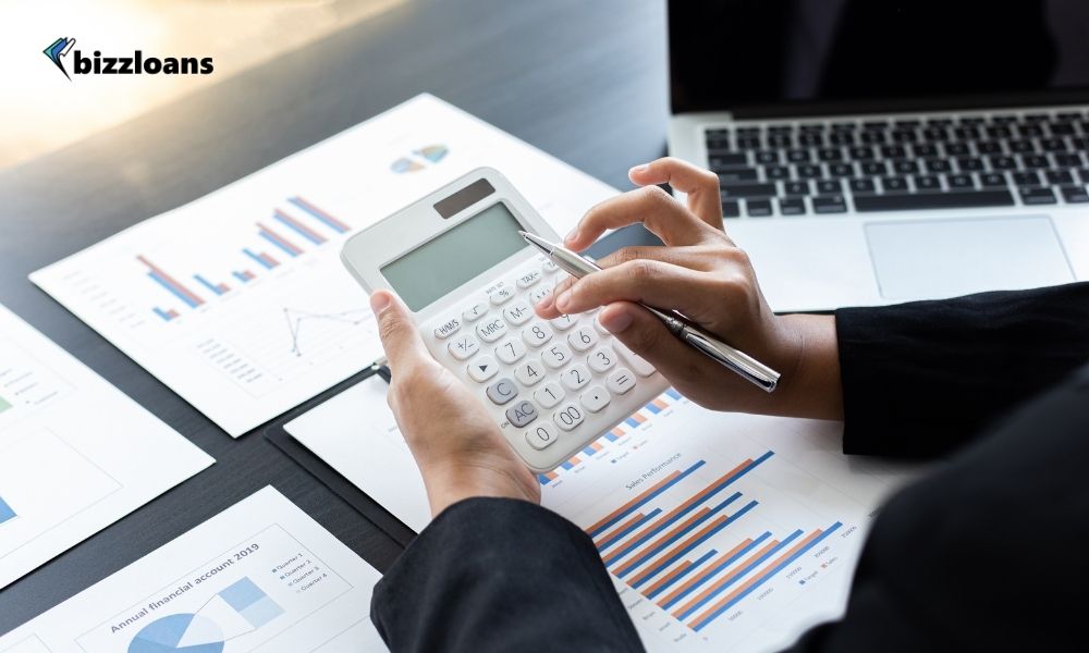 businesswoman using a calculator and pen