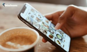 man using his phone to promote his brand in social media