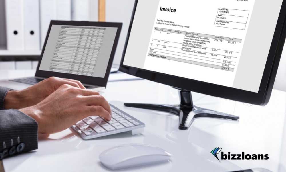 usiness person checking invoice on computer