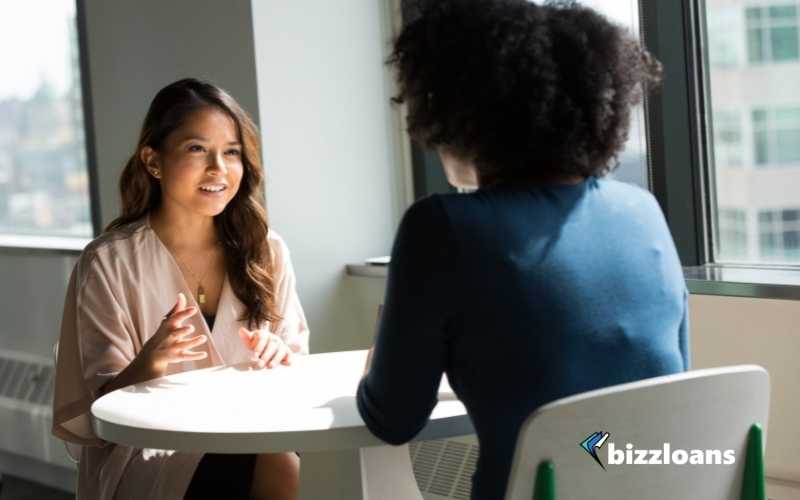 business woman talking to a female loan broker