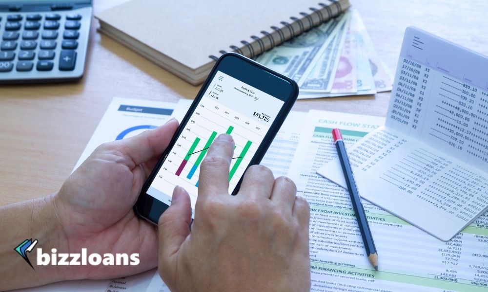 hand of a business owner managing his cash flow on his cellphone