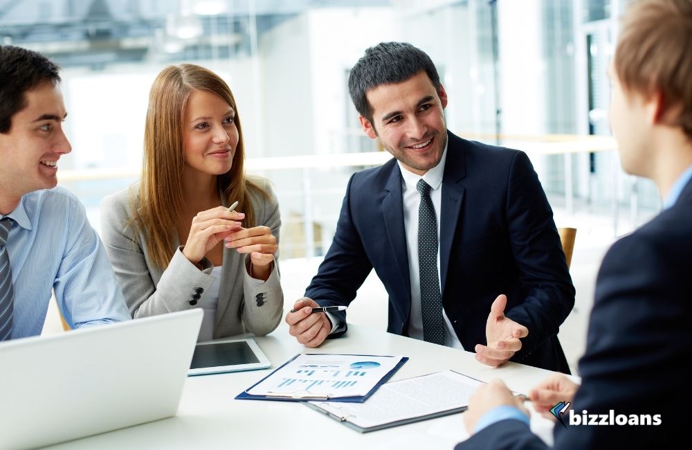 group of people talking about small business loans