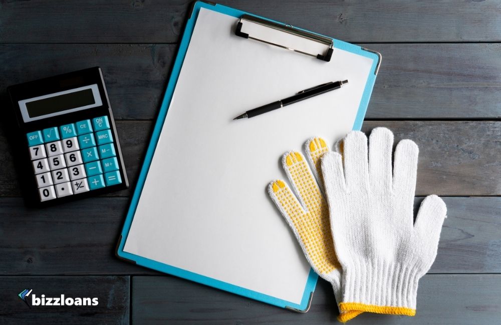 pricing strategy concept: pen, paper, calculator and gloves on the table