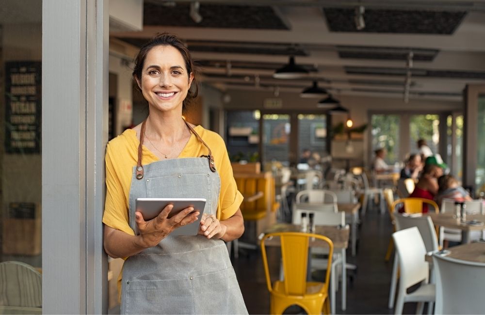 smiling business owner at entrance