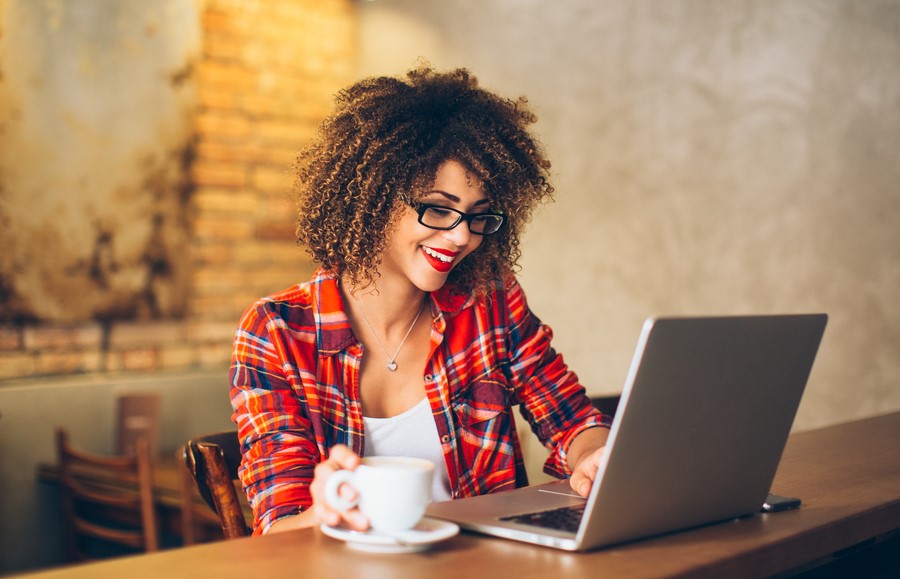 business woman comparing business loans on laptop in her shop