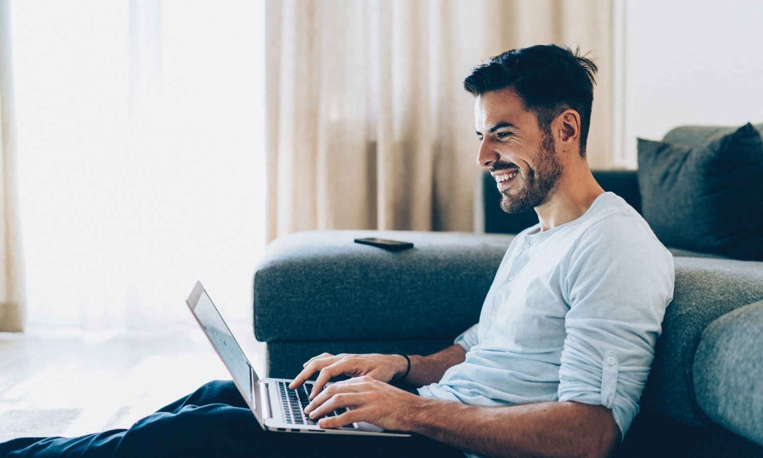 happy businessman looking for unsecured business loans on laptop