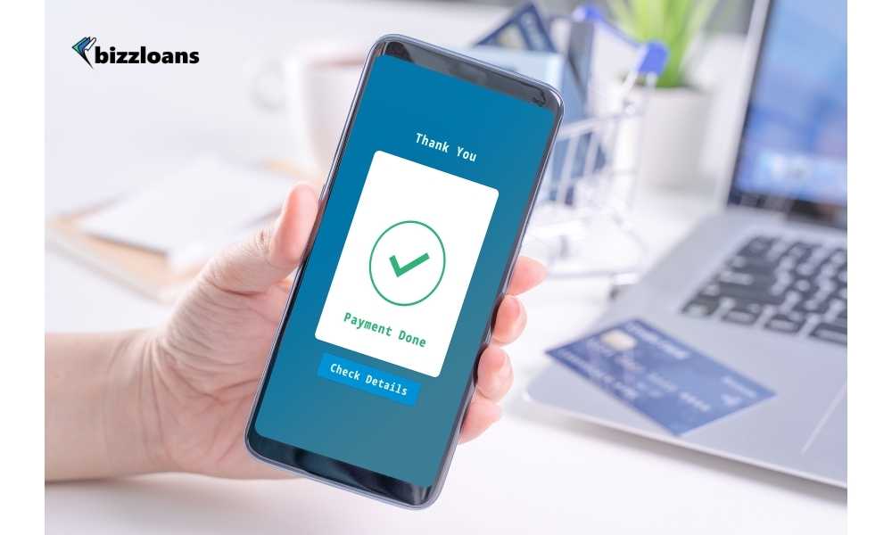 business owner making a mobile payment; payment done shown on mobile screen
