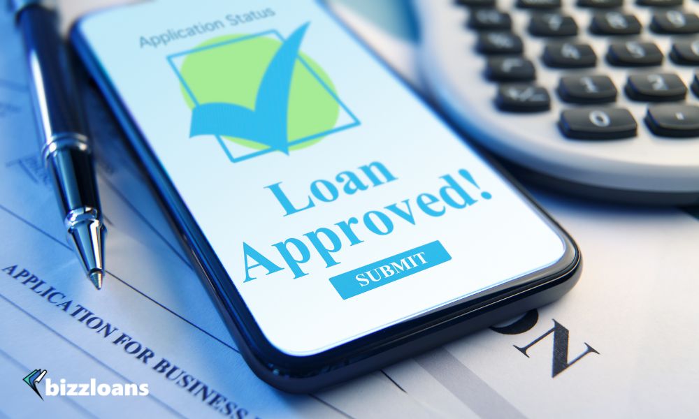 Mobile Device On Business Loan Application Document; Loan Approved