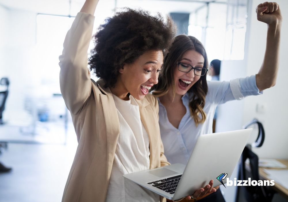 two happy business women getting business loans